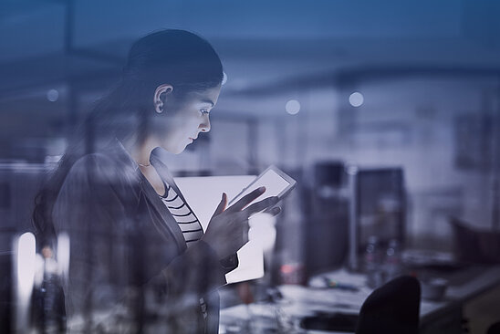 Shot of a young businesswoman working late in the office